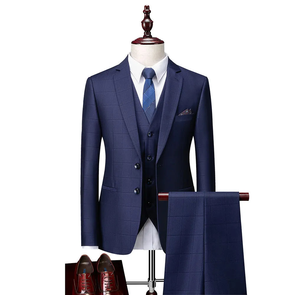 Man wearing a navy blue plaid slim-fit three-piece suit with jacket, waistcoat, and trousers
