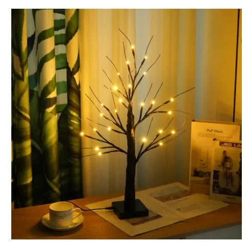 60cm tall white LED birch tree night light on a table, available in black, pumpkin, bat, or maple designs.