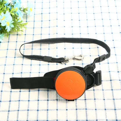 Retractable dog leash with handle and nylon cord in vibrant orange colour, extended to 3 metres.