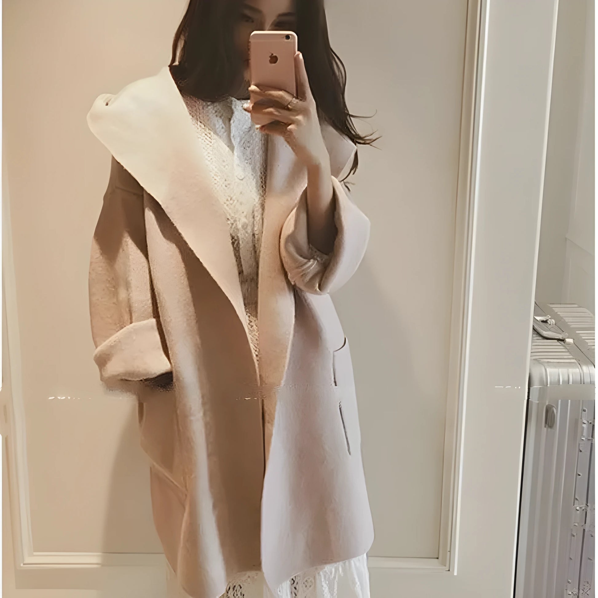 Plus size woman modelling a loose fit grey thin coat with lace detailing and long sleeves.