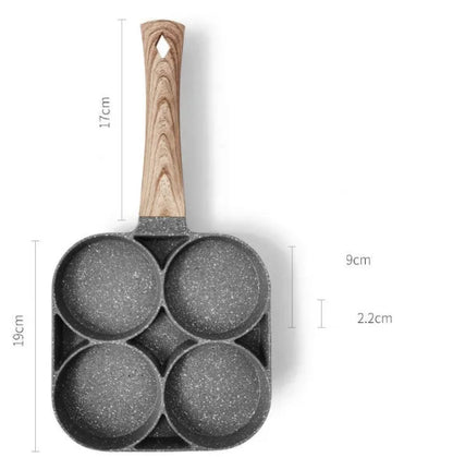 Four-hole aluminium frying pan with medical stone non-stick coating and bakelite handle on a hob