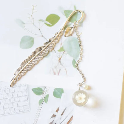 Dried flower bookmark with alloy frame measuring 12cm by 2cm, showing preserved botanical specimens