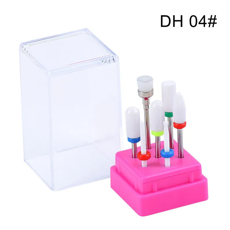 Set of six tungsten steel nail drill bits and a brush in a clear plastic case.