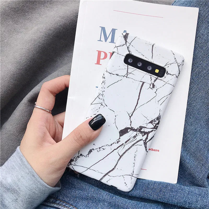 Samsung phone case with white and grey marble pattern on a polycarbonate back cover.
