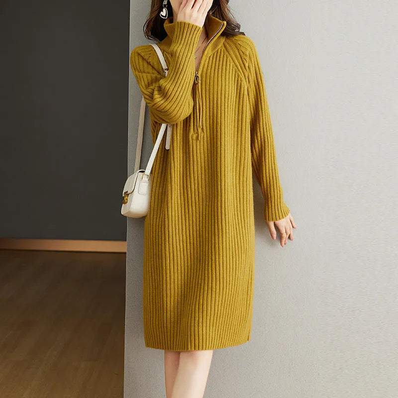 Beige half-zip woolen skirt with long sleeves, a stand collar, and a loose, straight midi silhouette.