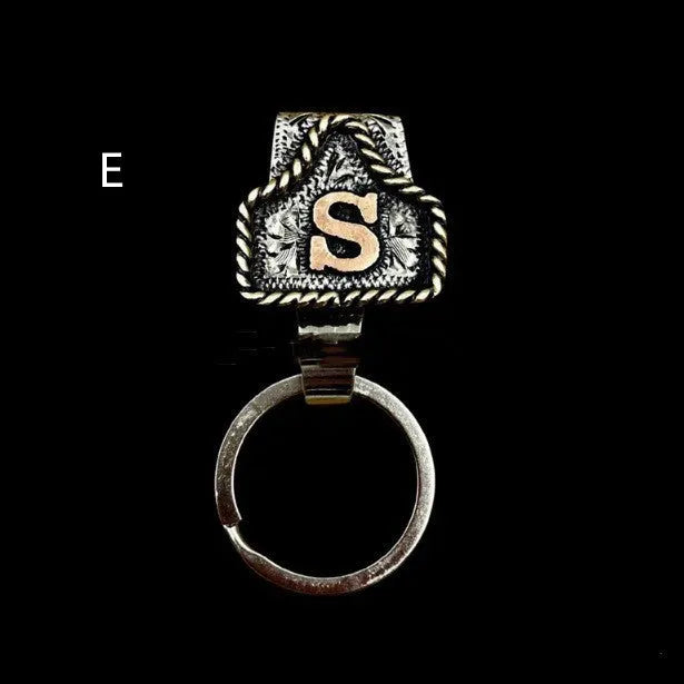 Handmade cow tag design metal keychain on a keyring, shown in one of many available colours.