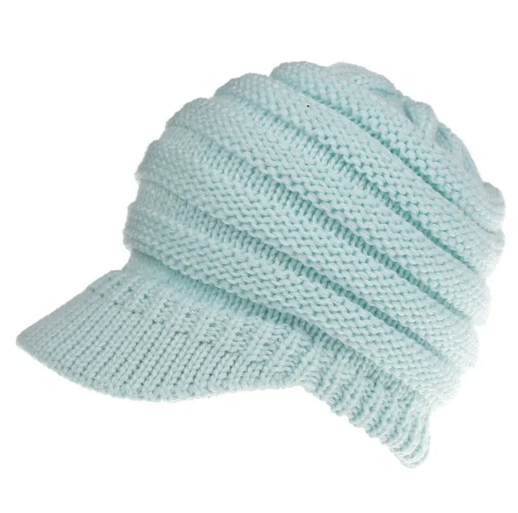Women's acrylic knitted ponytail beanie in a solid colour, shown on a model with a ponytail.