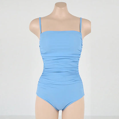 Sling style one-piece swimsuit with belly pleats in solid colour options