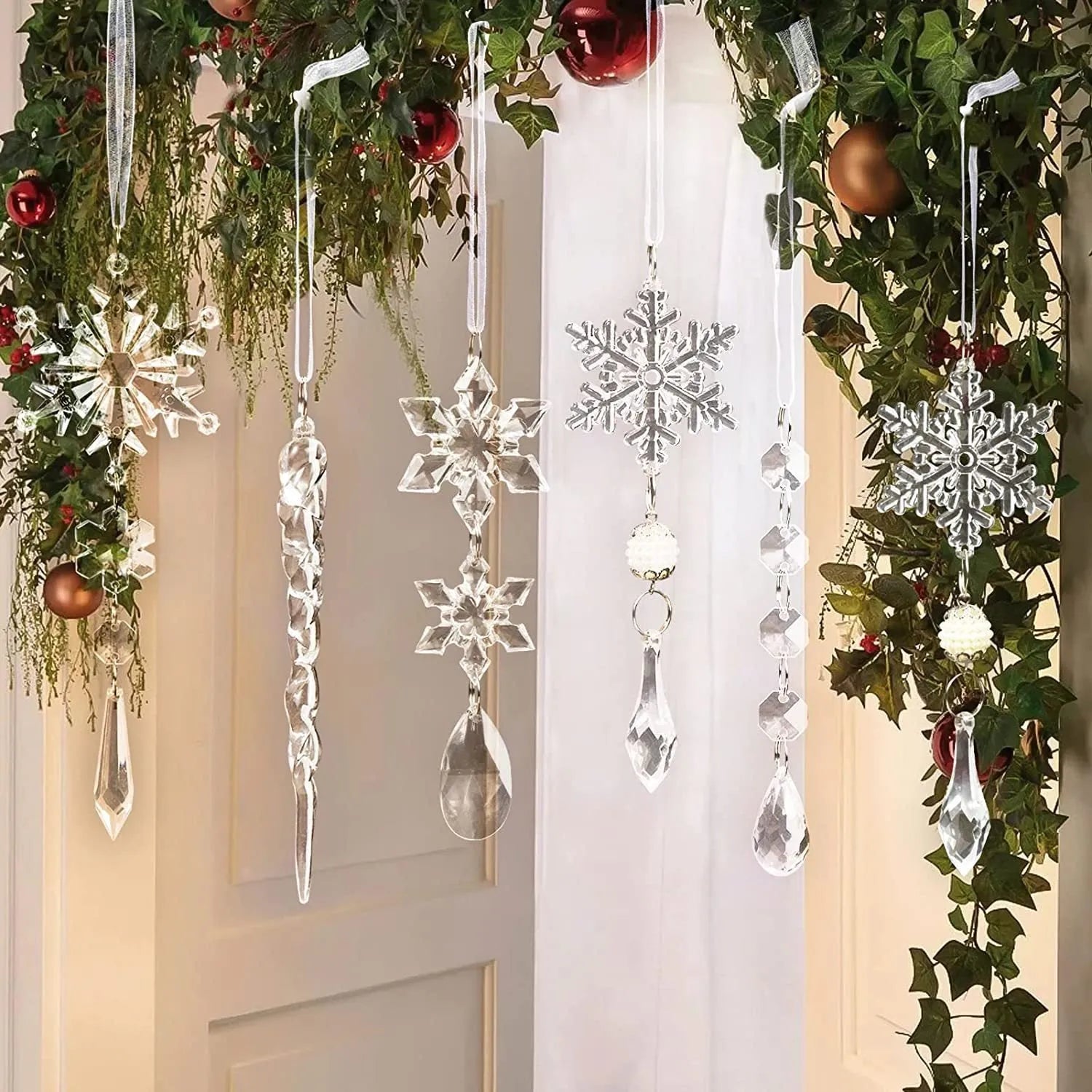 Ten clear acrylic icicle-shaped Christmas tree ornaments with white ribbon loops on a festive branch.