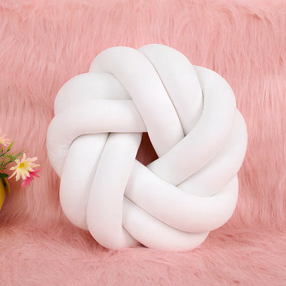 Knotted lumbar pillow with memory foam fill showing adjustable height feature and polyester cover