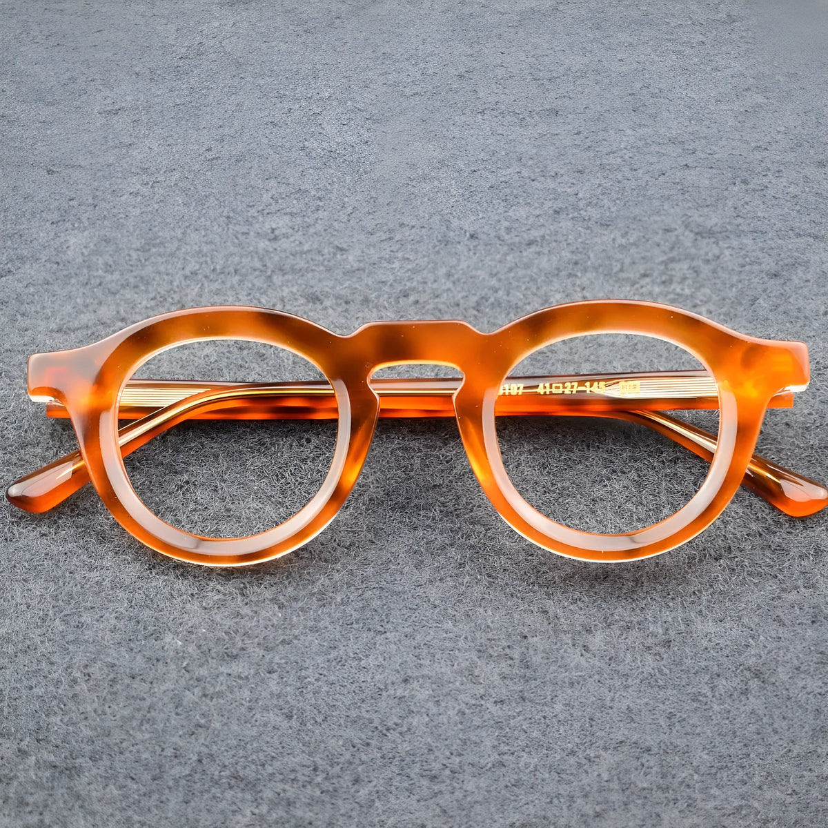 Box style hip-hop sunglasses with a thick colour-stitched plate frame on a solid background.
