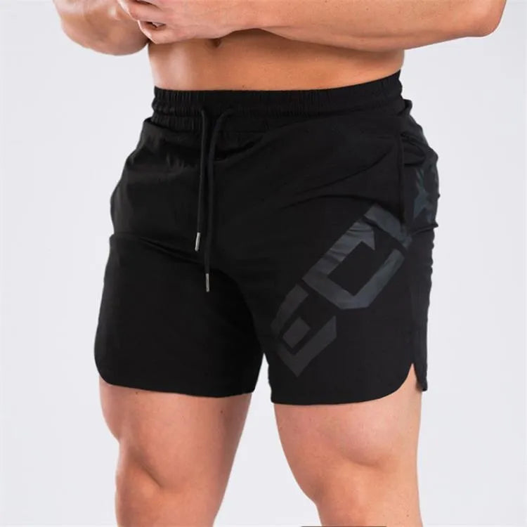 Man wearing black knee-length nylon training shorts with an elastic mid waist.