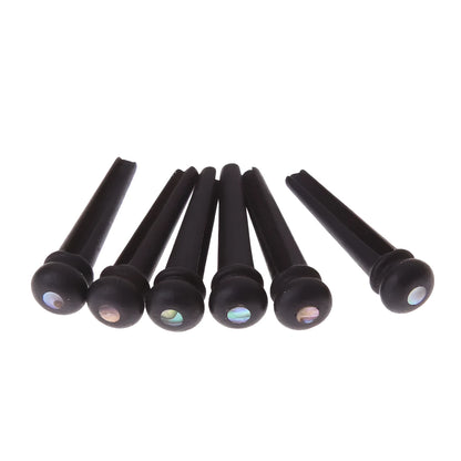 Six ebony folk guitar string nails with matte black finish and 5.3mm bayonet diameter