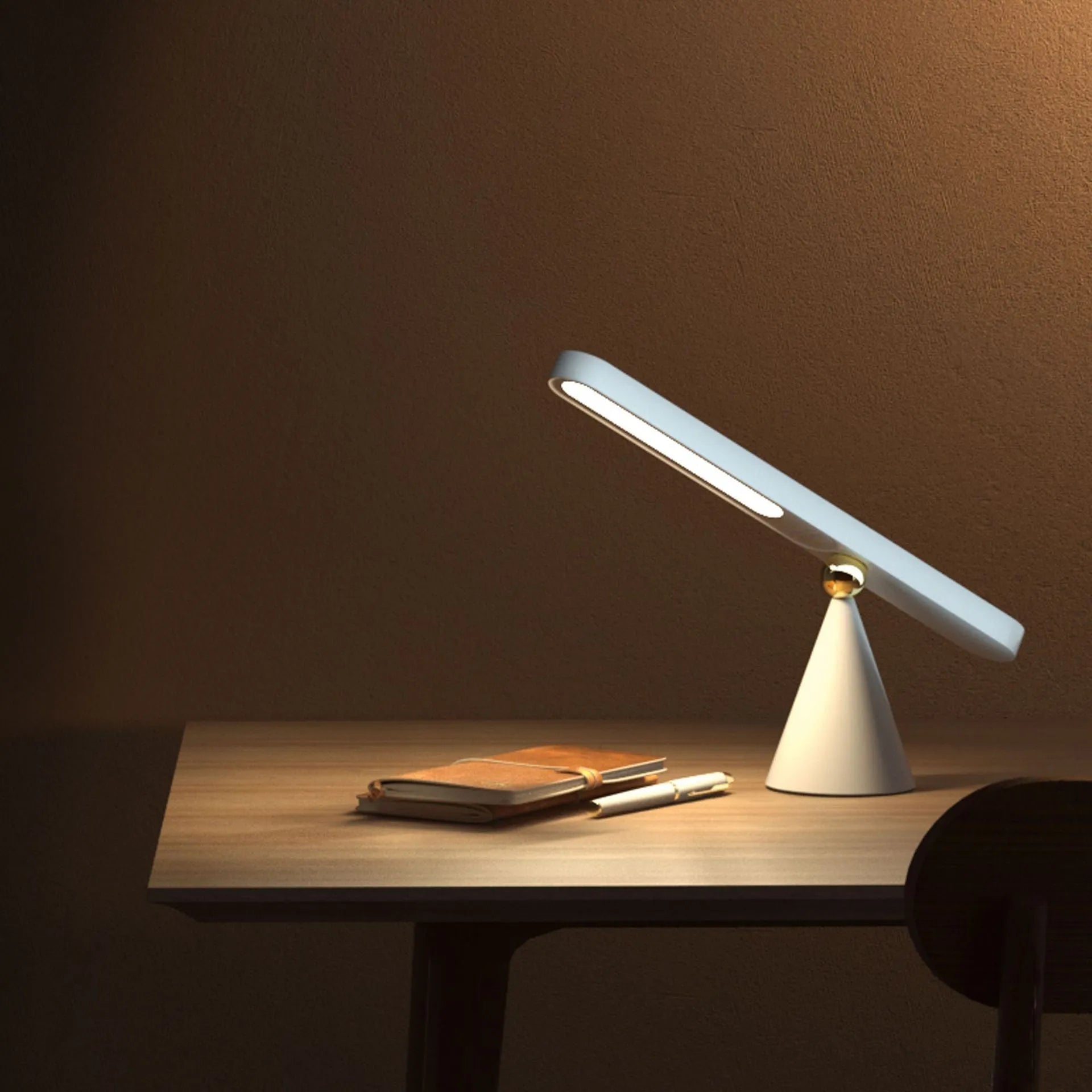 White geometric desk lamp with magnetic base and touch control on a wooden table.
