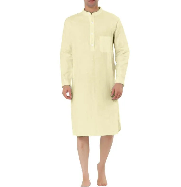 Man wearing a dark blue cotton shirt robe with button front, long sleeves, and side pockets.