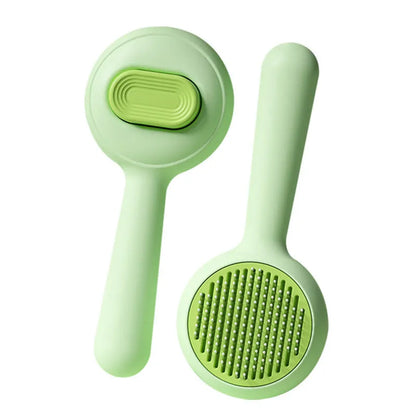 Green and yellow handled cat grooming brush with stainless steel pins on a white background