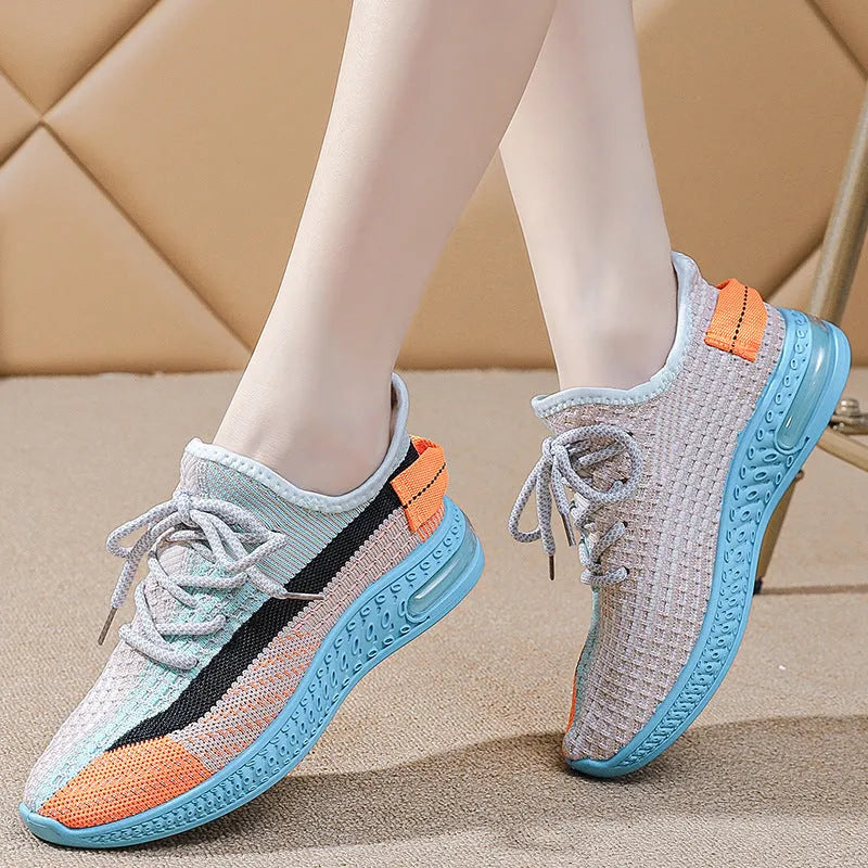 Women's casual running shoes in purple, black, and orange colours with fabric lining and plastic sole