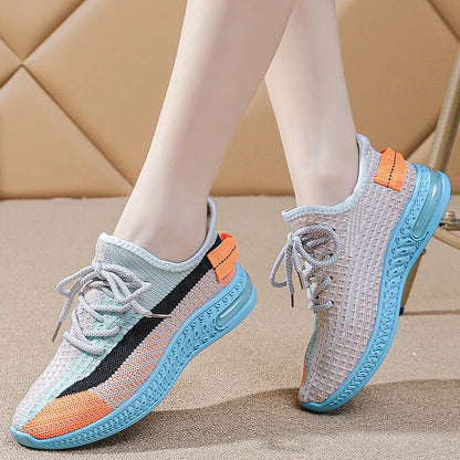 Women's casual running shoes in purple, black, and orange colours with fabric lining and plastic sole