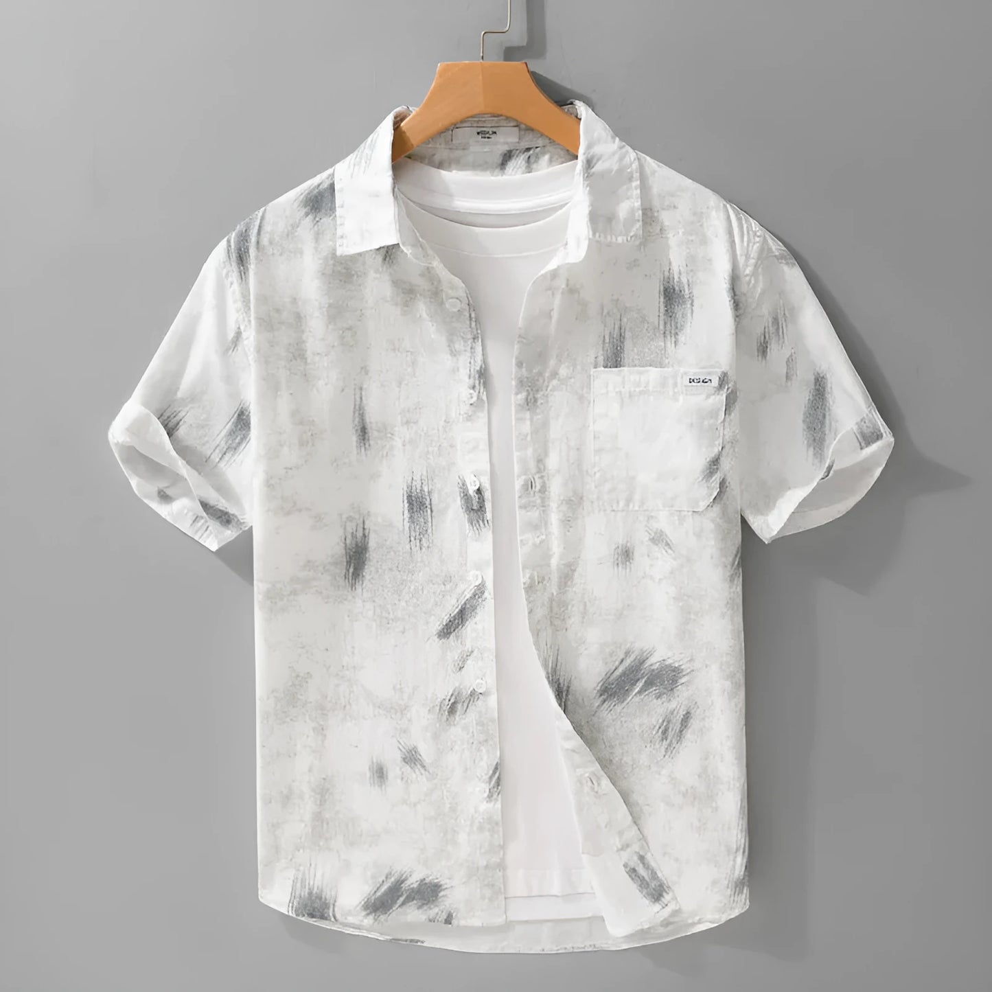 Light green men's loose-fit floral print short-sleeve cotton cardigan laid flat.