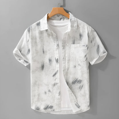 Light green men's loose-fit floral print short-sleeve cotton cardigan laid flat.