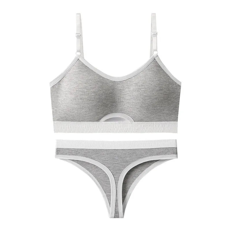 White underwired sports bra set with contrast dark grey back detailing and matching briefs on a mannequin.