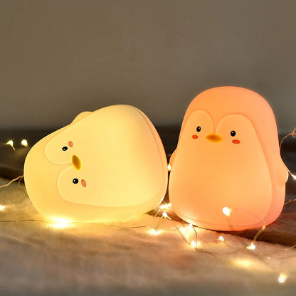 Penguin-shaped USB rechargeable night light with soft white glow
