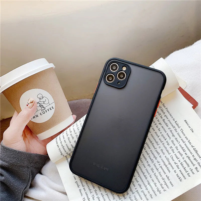 Solid colour silicone shockproof protective case for iPhone models on a table.
