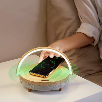 Wireless charging LED night light with Bluetooth speaker in marble pattern finish on bedside table