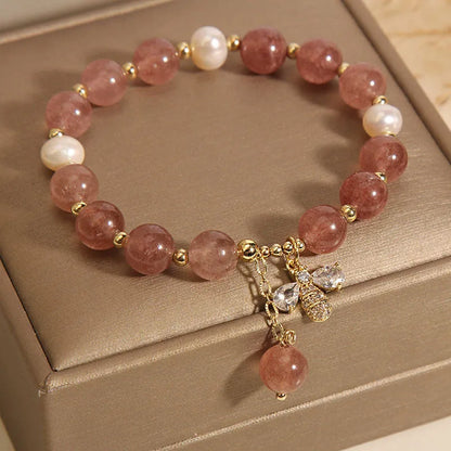 Women's adjustable bracelet with freshwater pearls, strawberry quartz stones, and bee charm