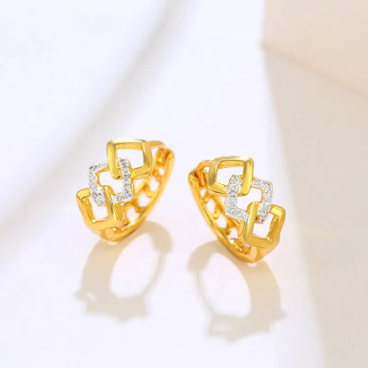 Pair of gold geometric earrings with hollow-out design and a two-tone colour detail on the ear clip fastener.