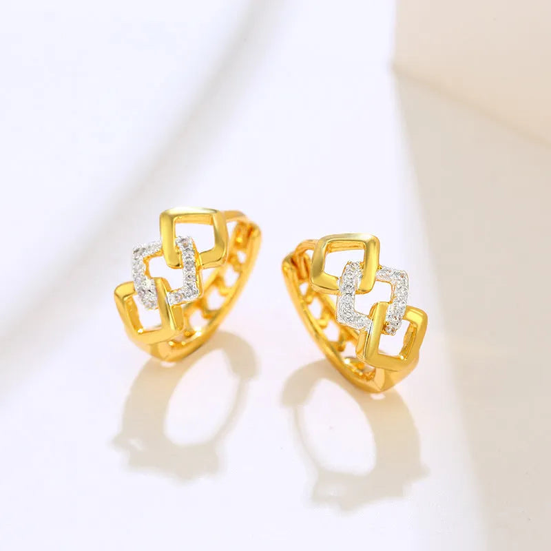 Pair of gold-coloured geometric alloy stud earrings with a hollow-out design on a plain background.