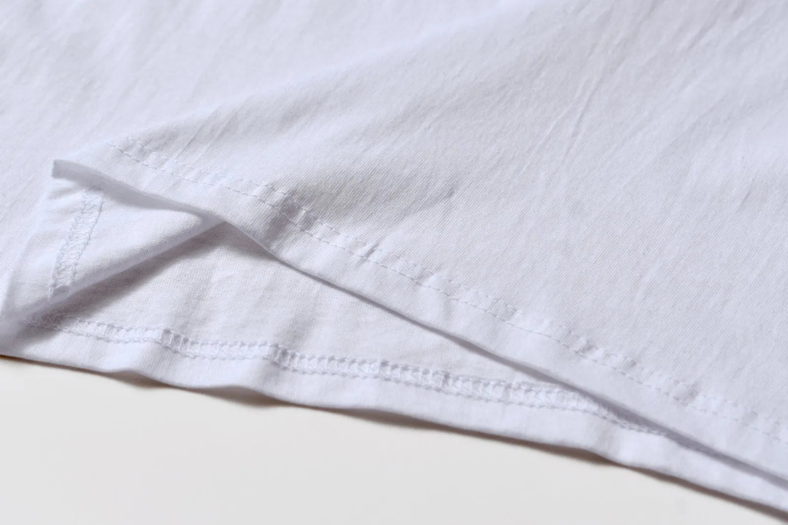White cotton T-shirt style overalls with short sleeves and loose fit pullover design