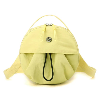 Out shoulder crossbody messenger bag in nylon showing interior zipped changing bag, phone pocket, and document compartment.