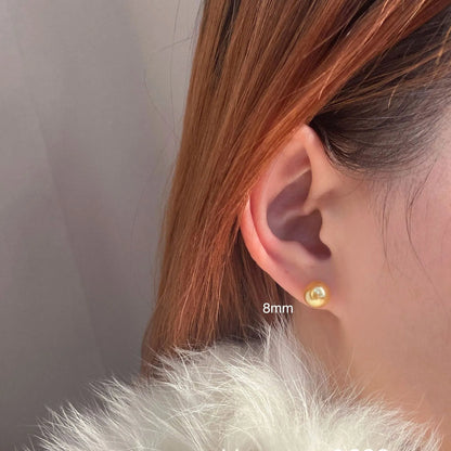 Geometric eight-point star pearl stud earrings in silver with cultured pearls, showing post-and-clasp fastening
