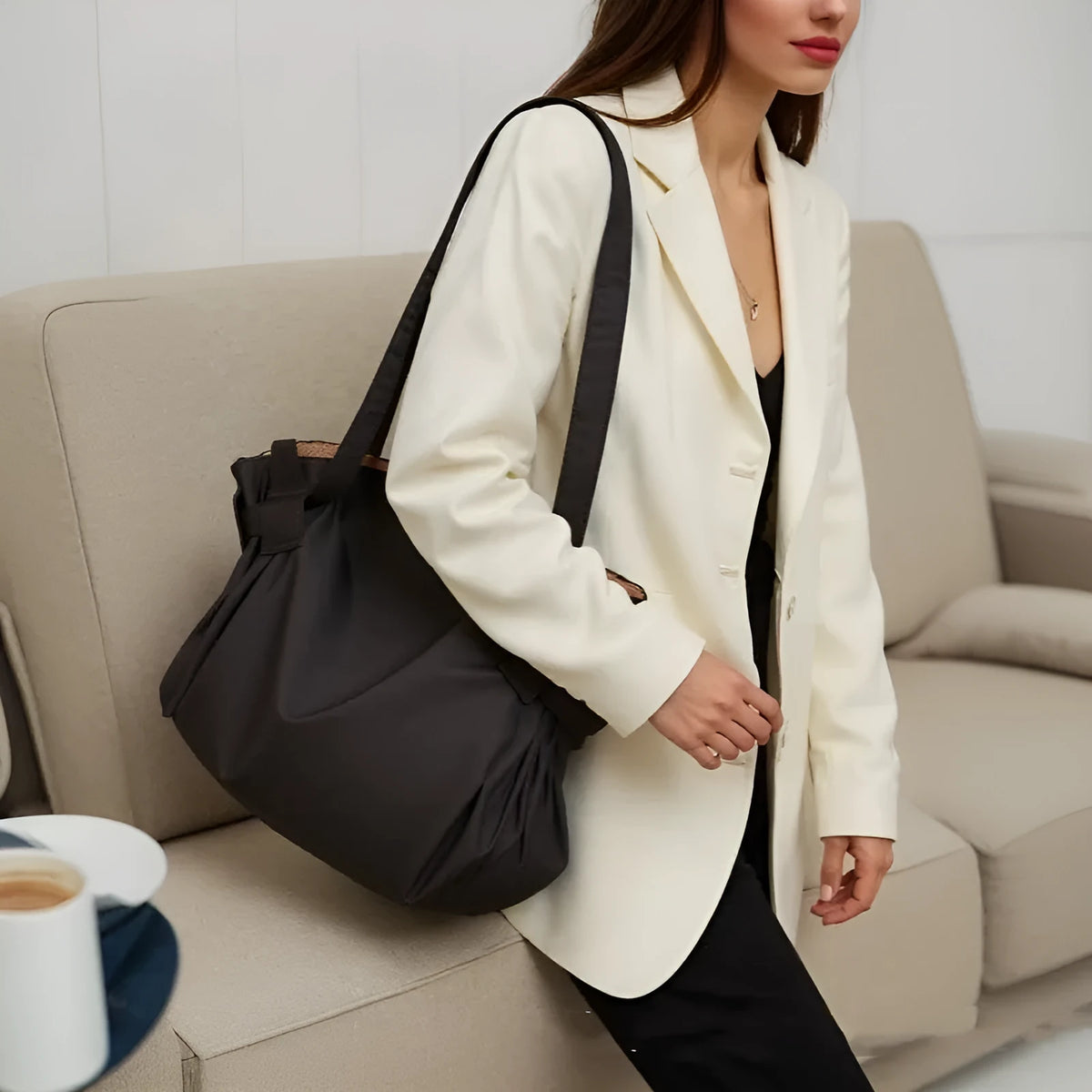 Women's black waterproof Oxford cloth crossbody shoulder bag with expansion function.