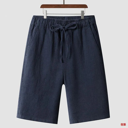 Men's beige linen casual shorts with a loose fit and elastic waistband on a neutral background.