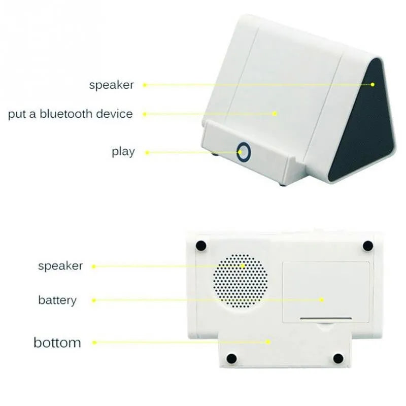 Compact black or white wireless Bluetooth speaker with charging cable.