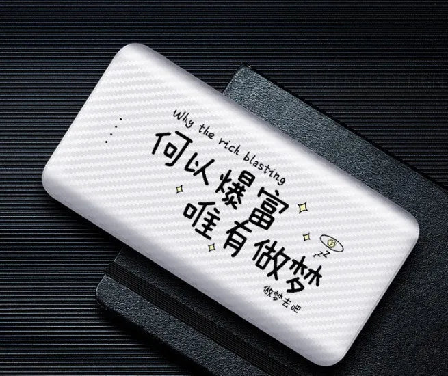 White portable power bank with 20000mAh capacity and multiple USB output ports on a table.