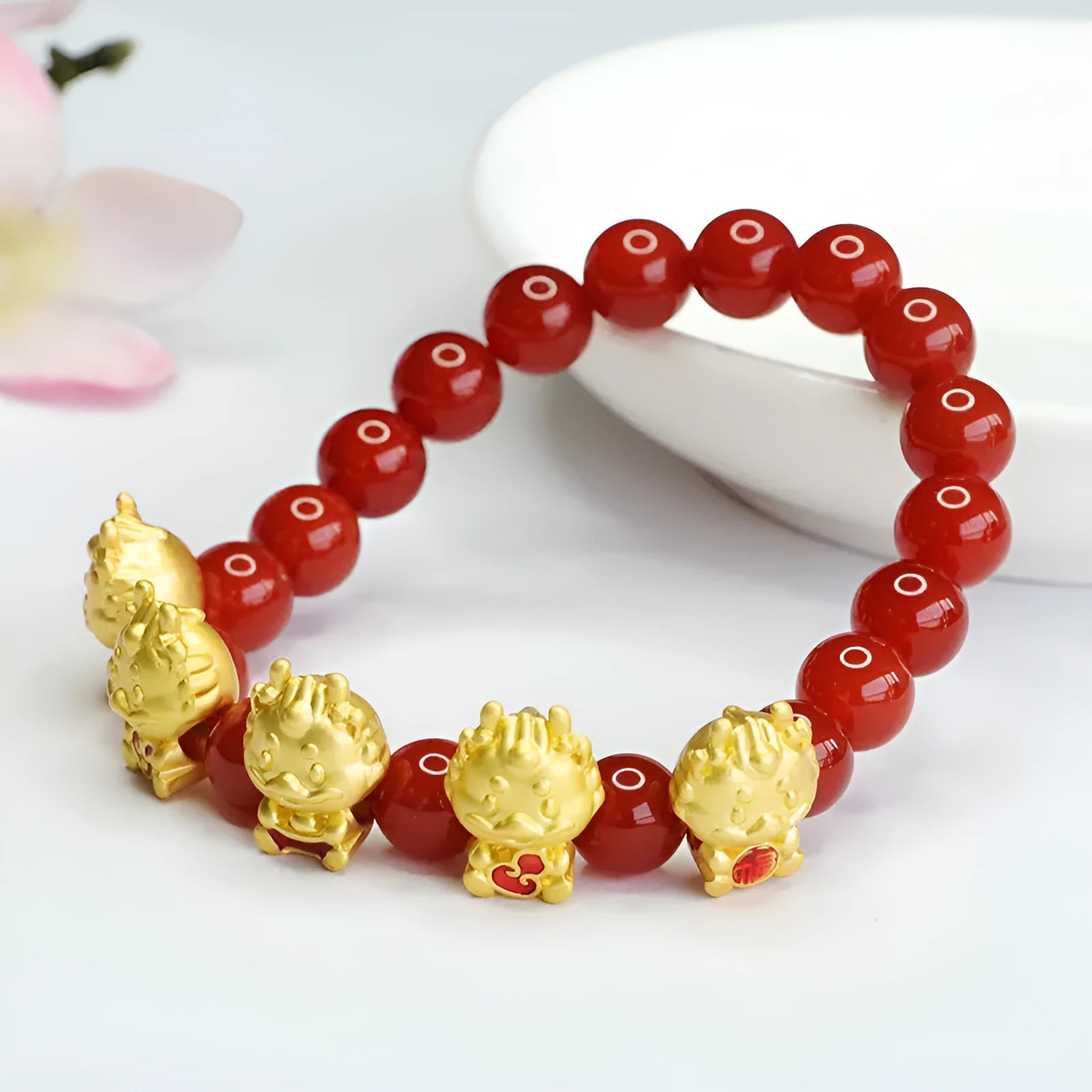 Red agate bracelet with carved five blessing dragon motifs on 8mm beads.