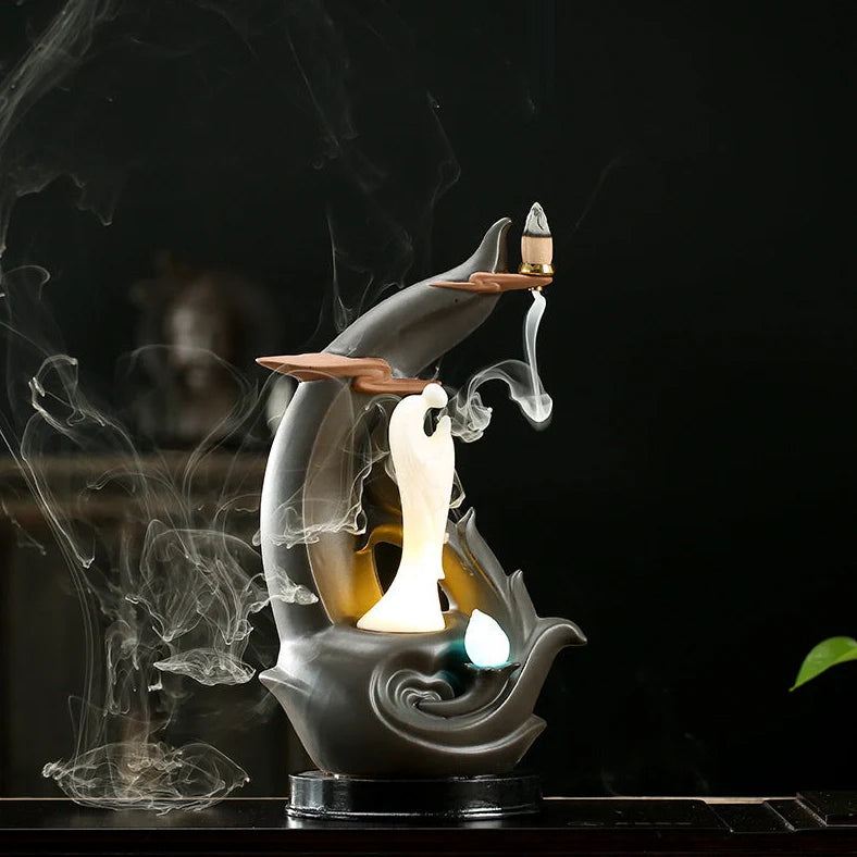 Purple clay tea pet ornament with downward flowing incense smoke and warm LED illumination