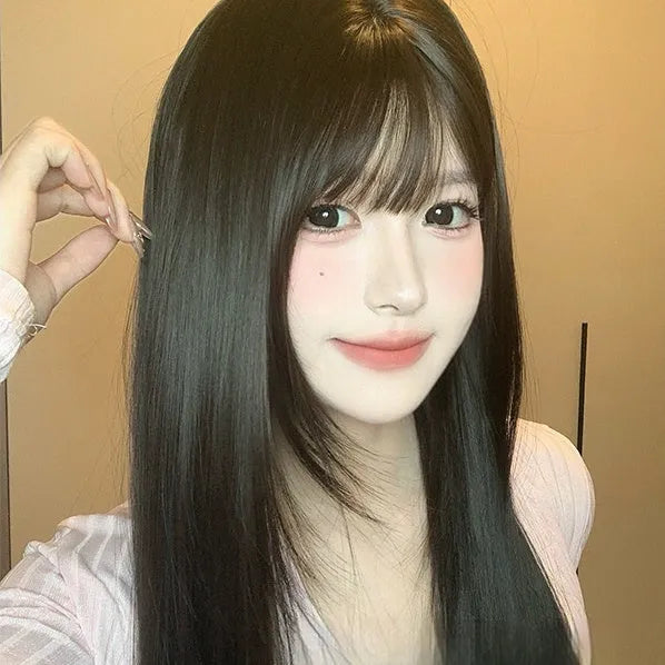 Dark brown long straight synthetic wig with fringe on a wig stand.