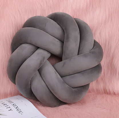 Knotted lumbar pillow with memory foam fill showing adjustable height feature and polyester cover