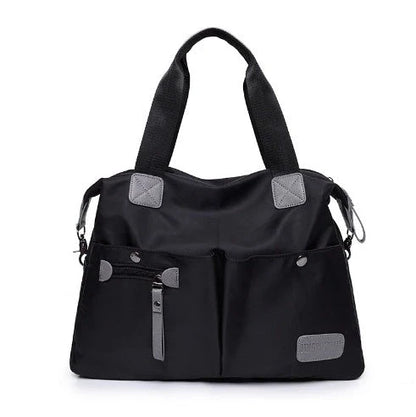 A fashionable and versatile ladies tote bag with multiple compartments and carrying options for the modern woman on the move.