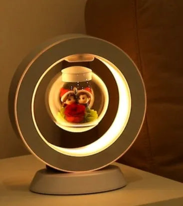 Pink rose eternal flower floating in magnetic levitation LED night light with triangular base and touch control