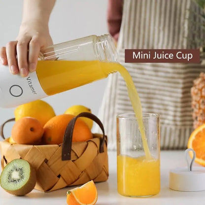 White portable USB rechargeable blender bottle with silicone handle on a Tritan cup.