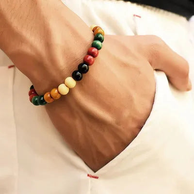 An ethnic-style natural stone bead bracelet with lava stones on a wrist.