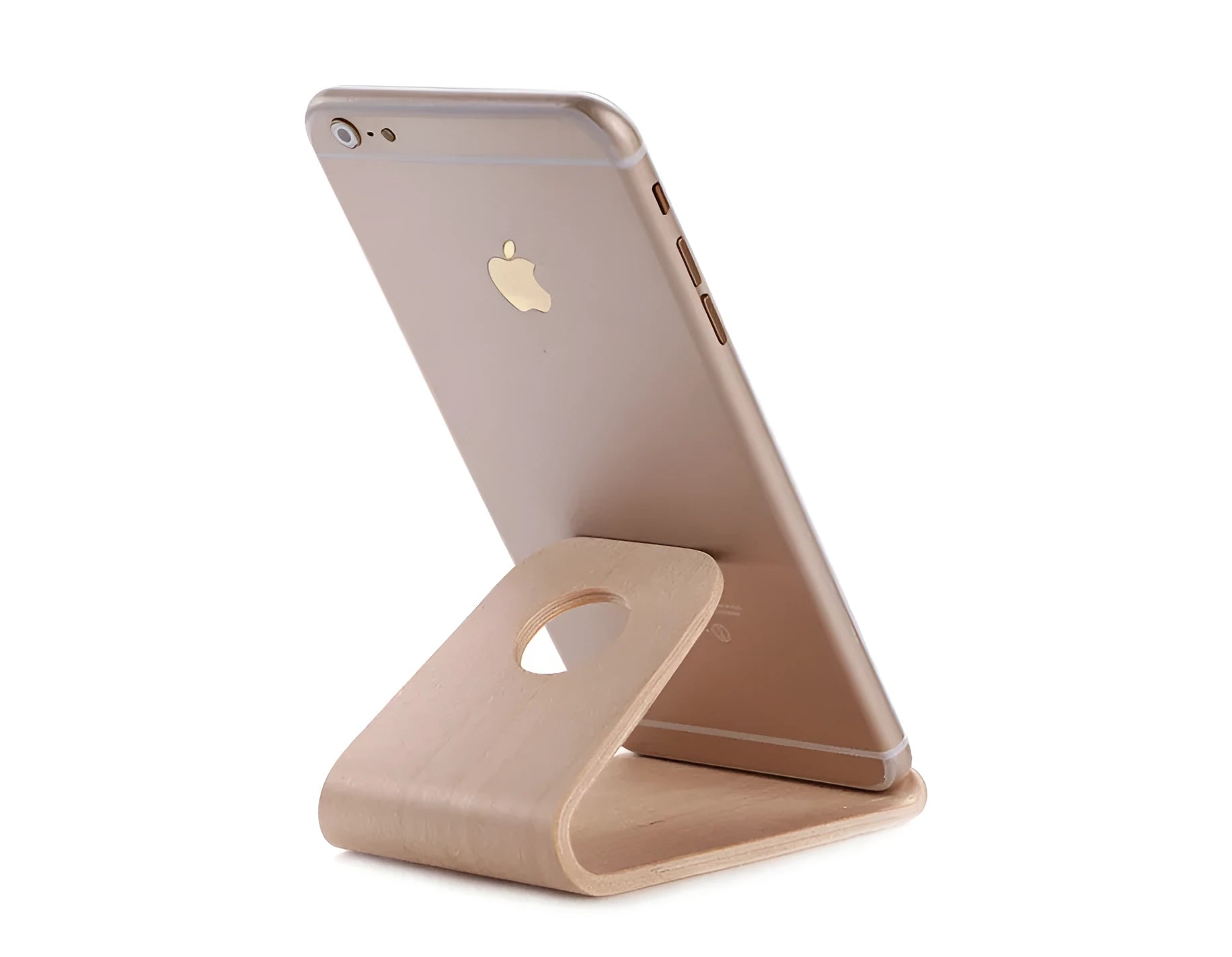 Solid wooden iPhone stand in Walnut finish on a desk, holding a mobile phone.