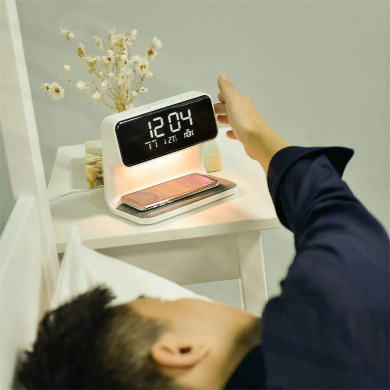 White 3-in-1 bedside lamp with wireless charging pad, LCD alarm clock screen, and touch controls.