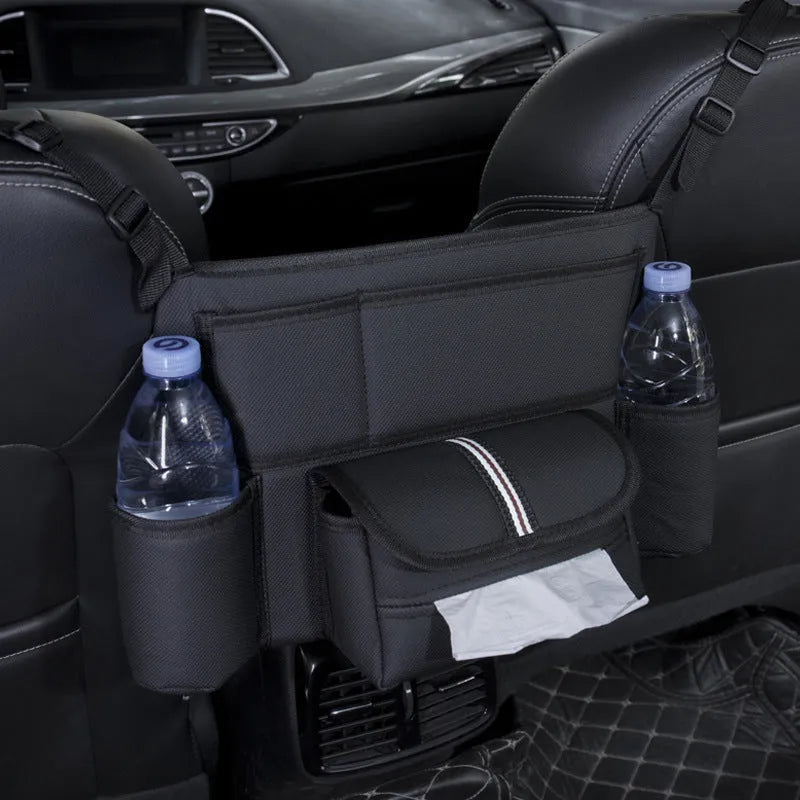 Black leather car seat gap storage bag hanging from armrest with tissue box, showing textured grain detail.