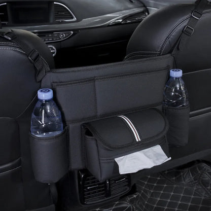 Black leather car seat gap storage bag hanging from armrest with tissue box, showing textured grain detail.
